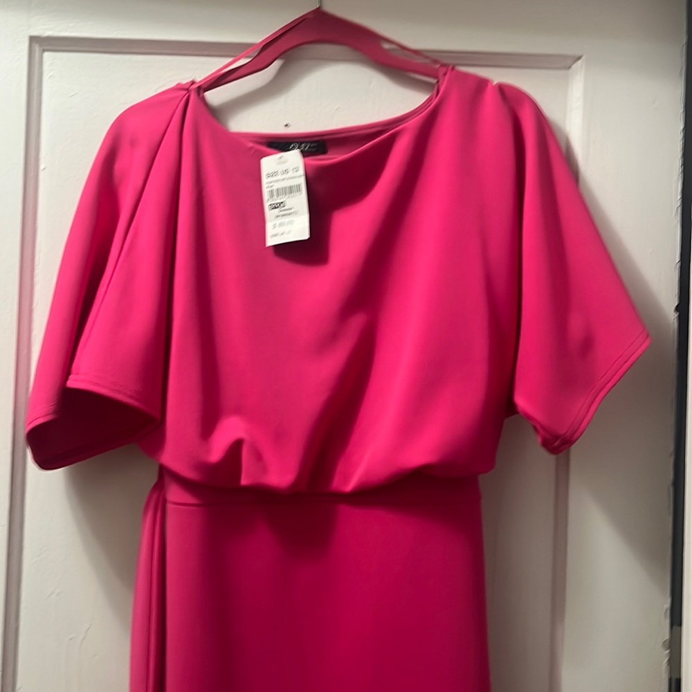 A bright pink dress with an asymmetrical bottom made for a variety of events!